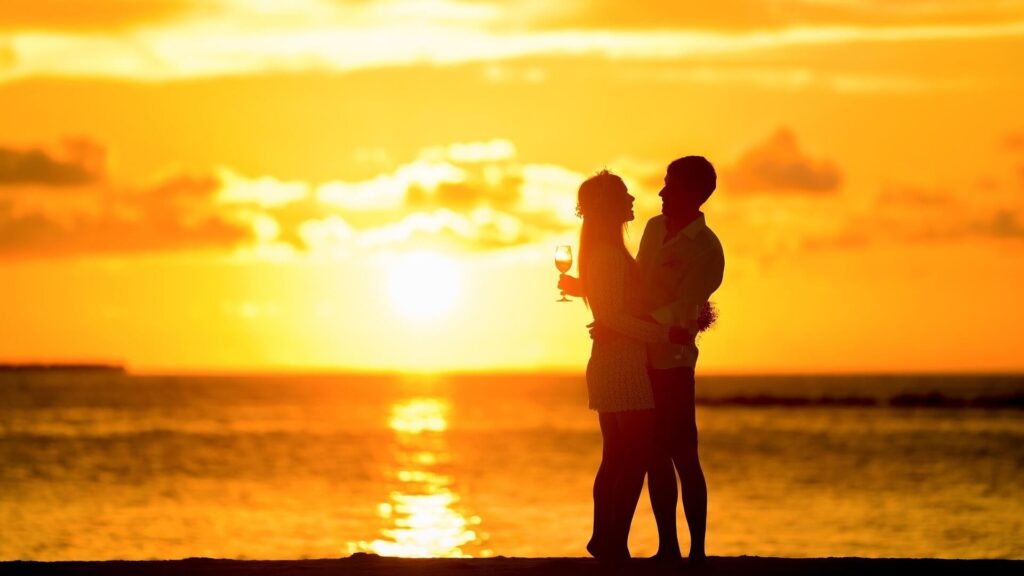 Couple on beach at sunset